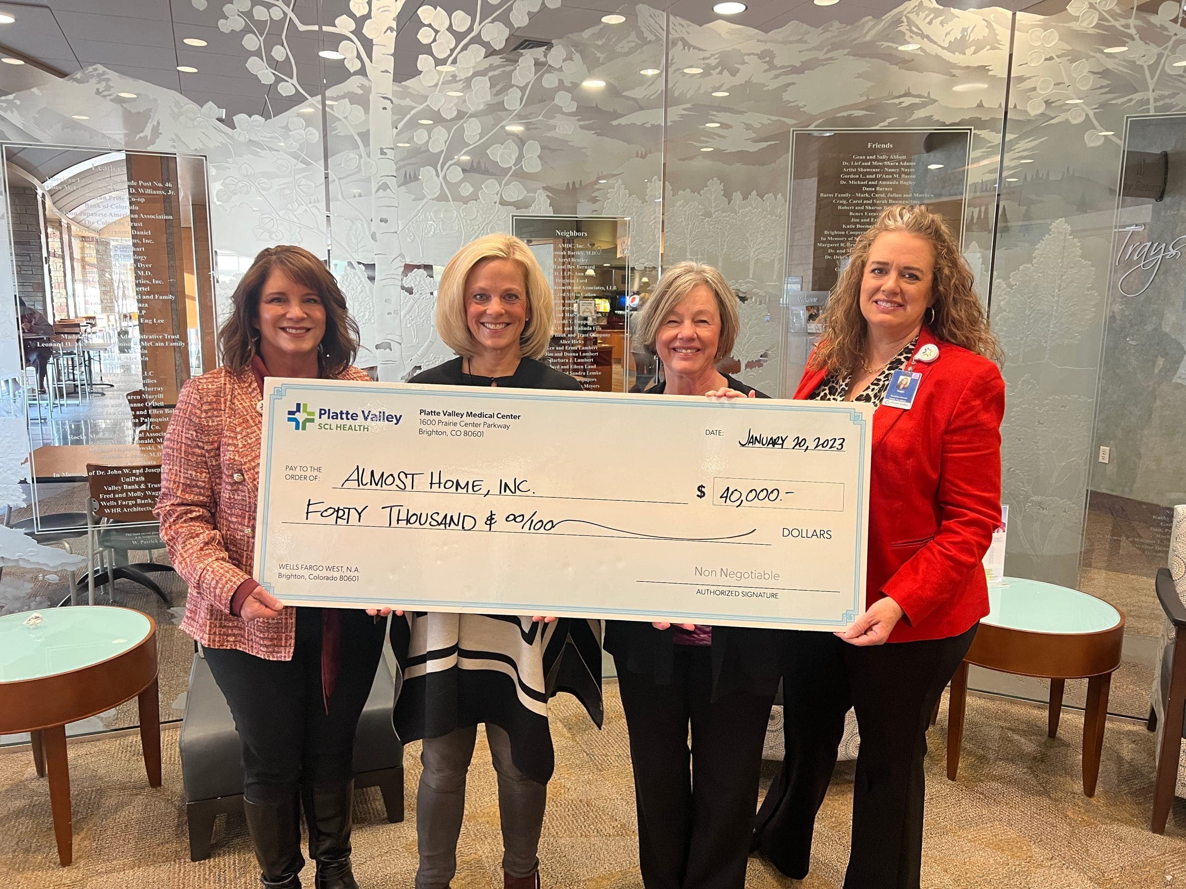 Four women holding a $40,000 Platte Valley Medical Center check made out to Almost Home