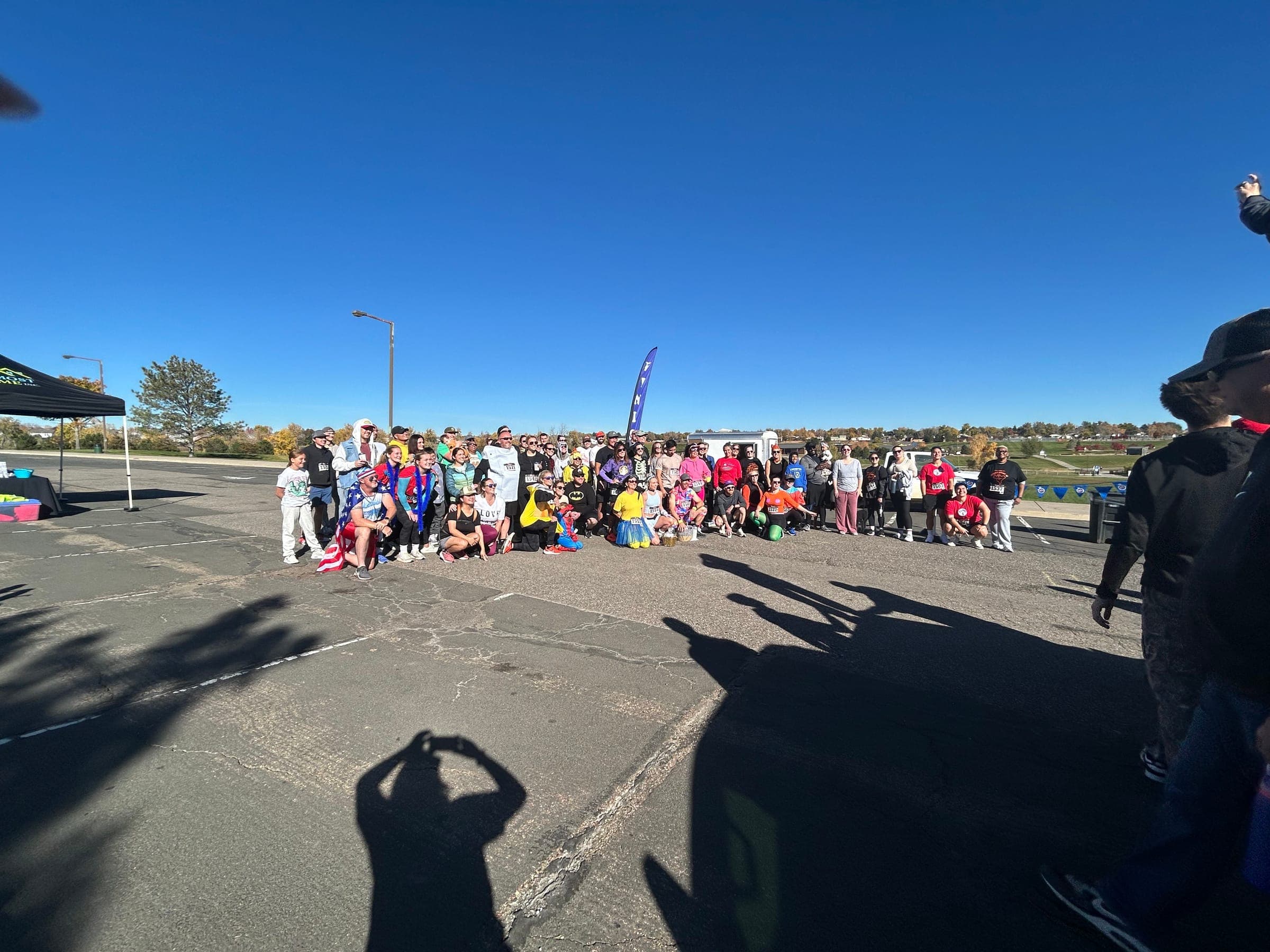 About seventy costumed Spooky Sprint 5K runners gathered before the race, with the Almost Home tent at left
